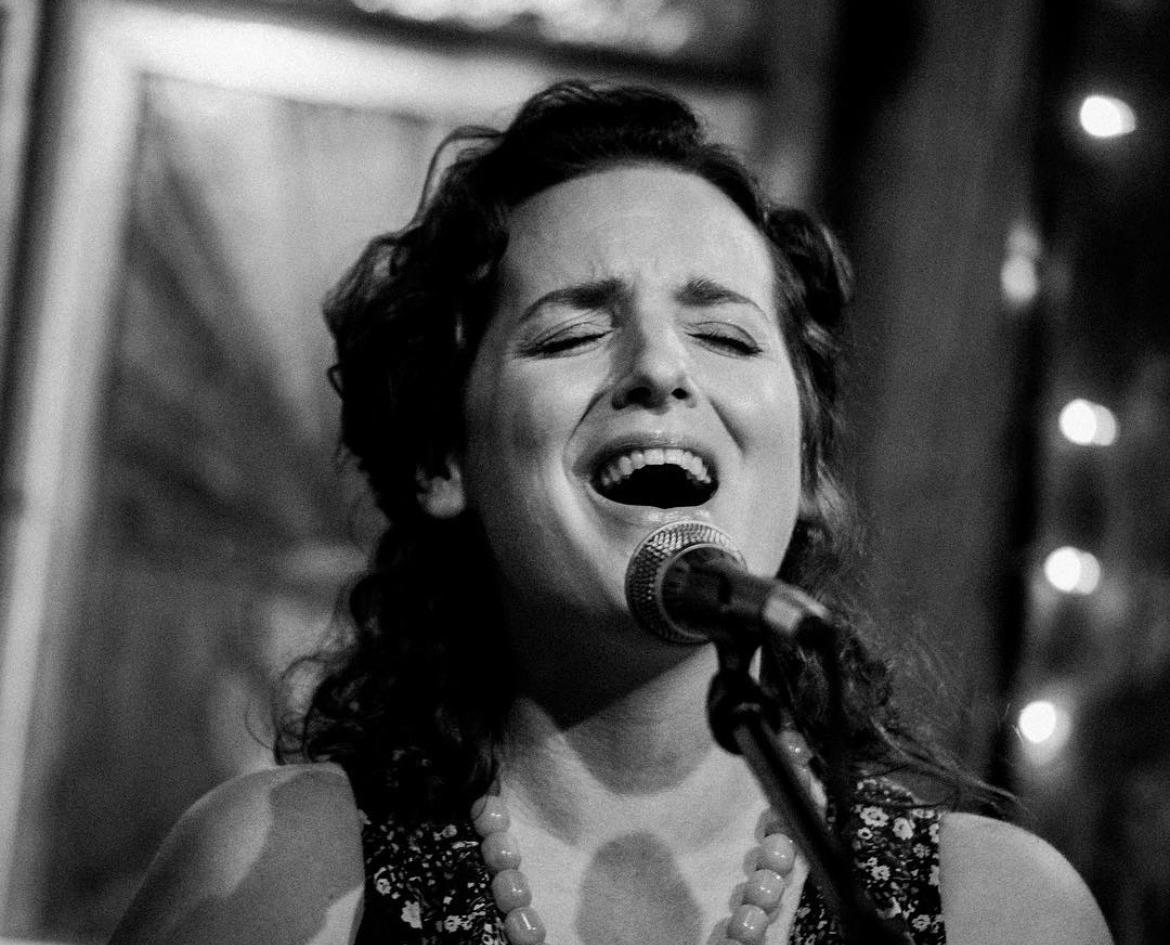 Black and white image, woman singing